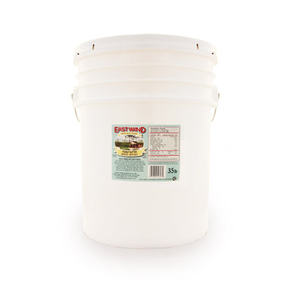 A 35 pound bucket of East Wind Nut Butters' Valencia peanut butter, smooth with salt.