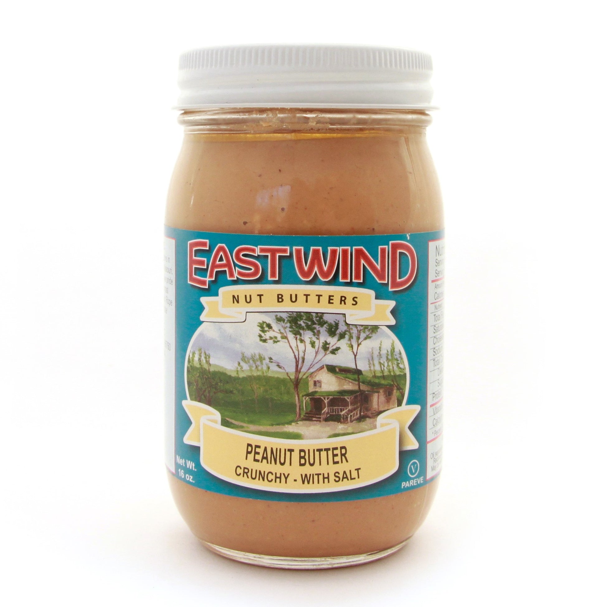 A 16 ounce glass jar of East Wind Nut Butters' Valencia peanut butter, crunchy with salt.