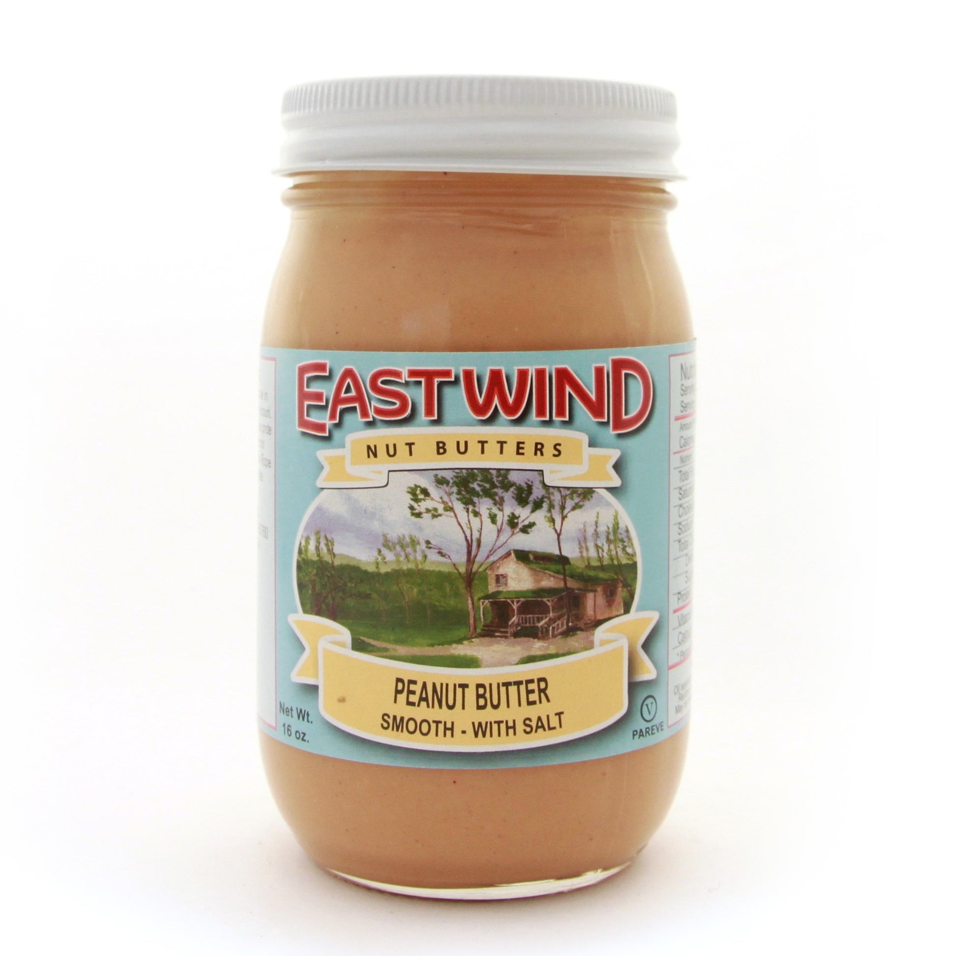 A 16 ounce glass jar of East Wind Nut Butters' Valencia peanut butter, smooth with salt.