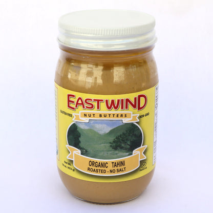 A 16 ounce glass jar of East Wind Nut Butters' organic tahini, roasted with no salt.